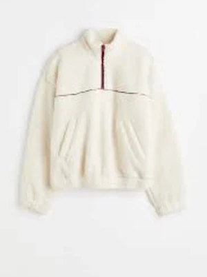 Vit teddytröja med röd dragkedja H&M - Vit teddytröja från H&M med halv dragkedja i rött. Tröjan har två snedställda fickor framtill, elastiska muddar och en avslappnad passform. Perfekt för lager på lager och chill dagar. Materialet är mjukt.