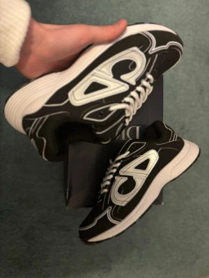 Svarta b30 sneakers med vit sula - Säljer ett par svarta b30 sneakers med vit sula och vita detaljer. 