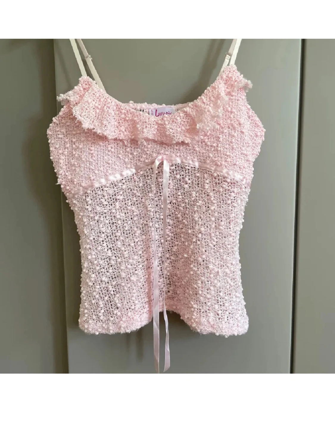 Ljusrosa linnetopp med rosett