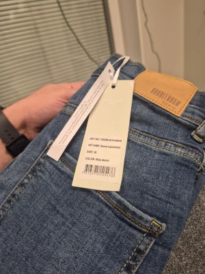 Blåa skinny jeans från Bubbleroom 38 - Säljer ett par blåa skinny jeans från Bubbleroom med klassisk femficksdesign och hög midja. Jeansen är i stretchigt denimmaterial och har en snygg passform som framhäver benen. Perfekta för dig som gillar en stilren och modern look.