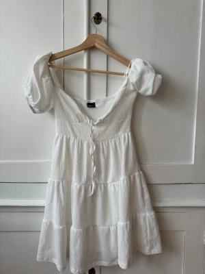 Vit klänning från Gina Tricot - Supersöt vit kort klänning från Gina Tricot. Storlek XS, endast använd vid en skolavslutning.