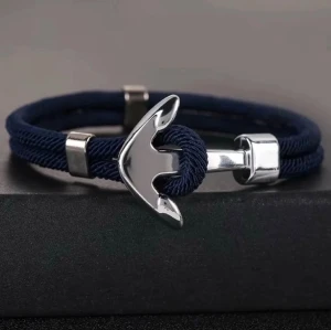 Marint armband med ankare - Stilrent armband med marinblått rep och ett silverfärgat ankare i metall som lås. Perfekt accessoar för dig som gillar nautisk stil och vill ha något unikt på handleden. Passar både till vardagslooken och när du vill sticka ut lite extra.