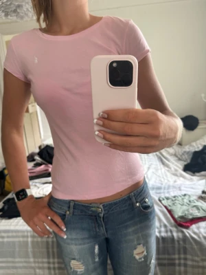 Ljusrosa t-shirt från Polo Ralph Lauren - XL men skulle säga att den sitter som en M. Säljer en ljusrosa t-shirt från Polo Ralph Lauren med klassisk rund halsringning och liten vit logga broderad på bröstet. T-shirten är kortärmad och har en slim passform. Perfekt till jeans eller shorts för en enkel och snygg look.