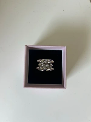 Silvrig ring med nitar - Cool silvrig ring med nitar från Edblad. Ringen är i mycket bra skick. Storlek M (17,50mm). 