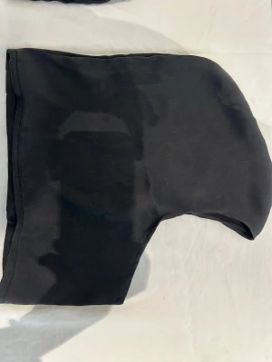 Svart balaklava i äkta siden, som skyddar sminket från atg förstöras och håret från slitage! - En svart balaklava i äkta siden, handgjort för att lösa ett problem som många har i vardagen men inte snackar om. Siden tyget skyddar håret mot slitage och får sminket att hålla under hjälmen (skyddar den från att förstöras också). Enkel design utan synliga loggor eller detaljer, täcker huvud och hals. Perfekt för kalla dagar eller som stilren accessoar. 💕