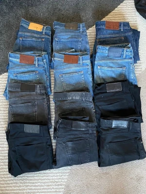 Tiger of sweden jeans bulk x12 - Säljer ett gäng snygga jeans i olika blå och svarta nyanser. Modellerna varierar mellan slim och regular fit, vissa med klassiska läderpatchar bak. Perfekta för dig som vill ha flera stilar att välja mellan. Materialet är denim och bomull. Bulk med tiger of sweden jeans x12