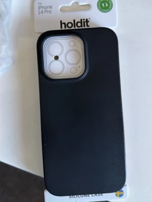 Svart silikonskal Holdit iPhone 14 Pro - Tja säljer skal för iPhone 14 Pro det är holdit skal köpte den från täbys ica maxi har använt den bara några gånger dock vill inte ha den  