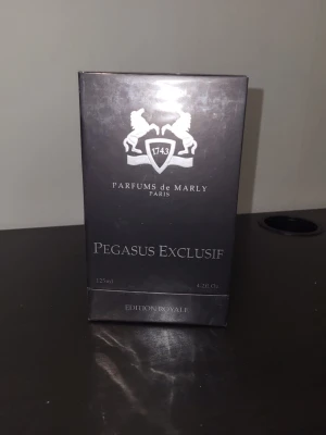 Parfums de Marly Pegasus Exclusif - Parfums de Marly Pegasus Exclusif är en lyxig parfym i en elegant mörkgrå förpackning med silverdetaljer. Flaskan rymmer 125 ml och tillhör Edition Royale-serien. Märket är känt för sina exklusiva dofter inspirerade av 1700-talets Frankrike. Har använt den en gång 