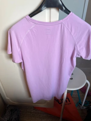 Ljuslila tränings-tshirt Pro Touch - Säljer en ljuslila tränings-tshirt från Pro Touch med korta ärmar och rund hals. Tillverkad i ett snabbtorkande funktionsmaterial (DRY PLUS) som passar perfekt till träning och sportaktiviteter.