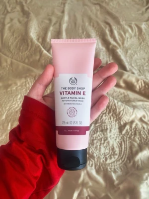 Vitamin E ansiktstvätt från The Body Shop - Ansiktstvätt med vitamin E från The Body Shop. Tuben är ljusrosa med svart kork och innehåller 125 ml. Passar alla hudtyper och innehåller vetegroddsolja för extra fukt. Perfekt för daglig rengöring.
