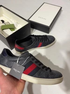 Gucci Ace Sneaker - Svarta Ace Sneakers från Gucci. Små creasingar samt liten skada på ormskinnet på hälen samt liten spricka vid creases annars helt fläckfria. Allt og tillkommer, dvs kvitto, låda, extra snören och dustbags.