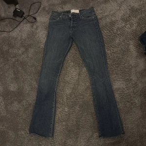 Blå bootcut jeans från Gina Tricot - Säljer ett par klassiska blå bootcut jeans. Jeansen har fem fickor, normal midja och dragkedja med knapp. Materialet är denim med lätt tvättad look och raka ben som går ut lite nedtill. Perfekta till en avslappnad stil. Dem är super försmå för mig så kan tyvärr ej testa…