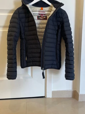 Svart dunjacka från Parajumpers - Snygg svart dunjacka från Parajumpers. Använd ett par gånger men ser helt ny ut. Passar som XS/S. Säljer då den inte kommer till användning. PRIS KAN DISKUTERAS!!