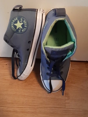 Denim blue Converse trainers  - Very cool trainers in good condition. Size 38.5 (UK size 5.5). Light denim blue with darker denim blue laces and lime inside... a small discolouration on the right shoes inner side, hardly visible. EXCELLENT BARGAIN.