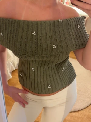 Offshouldertopp  - Snygg olivgrön offshouldertopp med stenar🥰