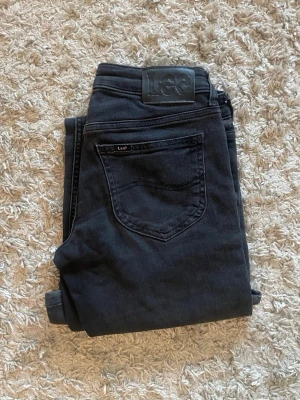 Svarta low bootcut jeans lee - Snygga svarta low bootcut jeans från Lee med klassisk femficksdesign och Lee-logga på bakfickan. Modellen heter Jessica och jeansen är i storlek 25/31 och passar xs, använda ca 3 gånger så i nyskick. Originalpris 1000