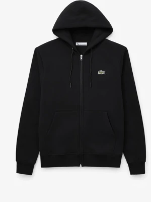Svart hoodie från Lacoste - Säljer en svart hoodie från Lacoste med dragkedja framtill och klassisk huva med snören. Ikoniska krokodilloggan på bröstet. Hoodien har långa ärmar och ribbade muddar. Perfekt för en clean och stilren look.