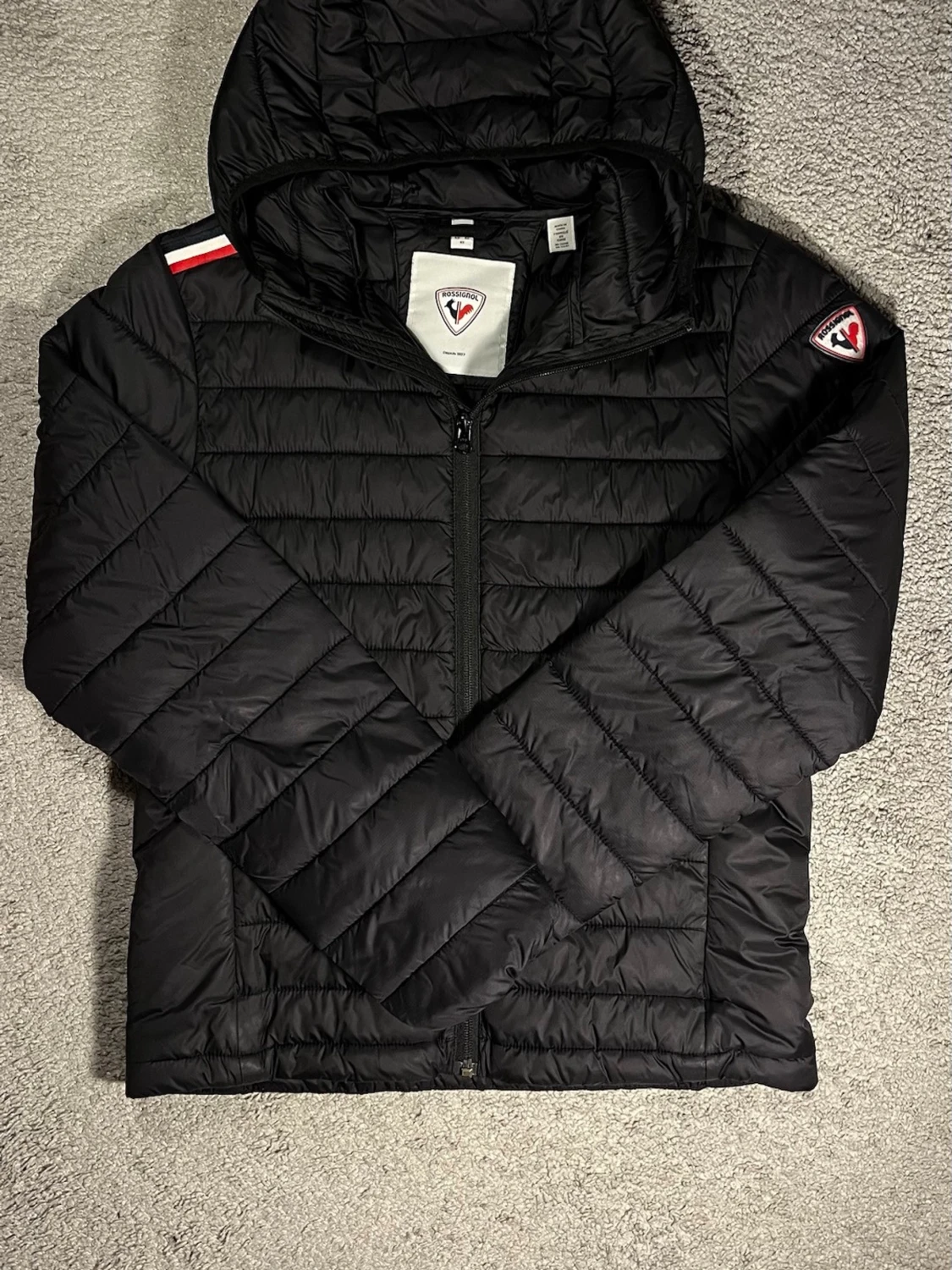 Svart dunjacka från Rossignol