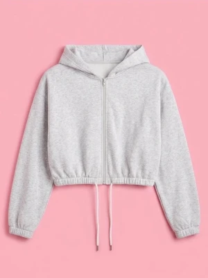 Grå croppad hoodie med snörning, S - Säljer en ljusgrå croppad hoodie med dragkedja och snörning i midjan. Tröjan har långa ärmar med resår vid ärmslut. Mjuk och skön, passar till jeans eller leggings.