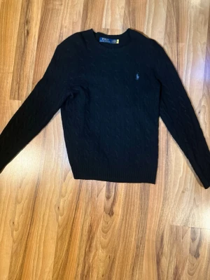 Ralph Lauren tröja - Säljer min Ralph Lauren tröja i kabelstickad Kashmir. Så gott som ny har använts 1 gång inga defekter alls. Köpt för ca 3000 på Johnells. Hör av dig vid frågor.