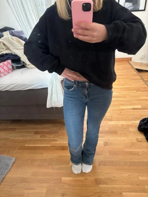 Blå raka jeans med hög midja - Säljer ett par klassiska blå jeans med rak passform och hög midja. Jeansen har fem fickor och stängs med dragkedja och knapp. Perfekta till en avslappnad stil och passar till det mesta. Materialet är denim i bomull.