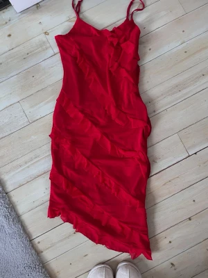 Röd långklänning  - Röd lång klänning från shein! Snedskuren längst ner, samma skurning bak som fram! Passar M-L
