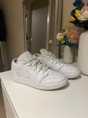 Nike Air Jordan 1 Low  - Säljer dessa Nike Air Jordan 1 low i hel vit. Skorna är i storlek 38,5! Skorna är i bra skick, dock är skosnöret ”sönder” på högra skorn. Skriv för ytterligare frågor:))