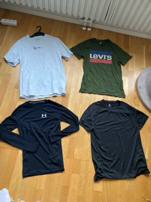 Svart långärmad träningströja Under Armour - Dessa tröjor är i bra skick och har inga defekter (de är dock inte strukna), Alla är i Storlek S förutom Karl Kani tishan som är i storlek XS (Den sitter dock som en M)💗Skriv gärna om ni har frågor🙃                                                    Bundle (alla 4): 320kr  Styckpris: Under armour och Karl Kani= 110kr/st        Hm sport och Levis tishorna= 90kr/st