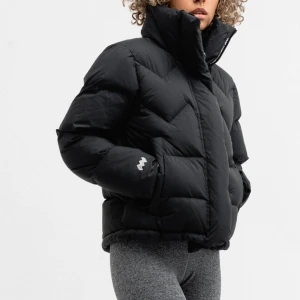 Mountain Work dunjacka strl.M  - Svart puffer dunjacka från Mountain  Work med hög krage och snyggt quiltat mönster.Strl. M men passar även S. Jackan har två sidofickor, dragkedja framtill och en skön passform. Materialet är nylon och dun, perfekt för kalla dagar. Diskret logga på ärmen och nacken. Nypris 3995kr. Obetydligt använd så fint beg skick.