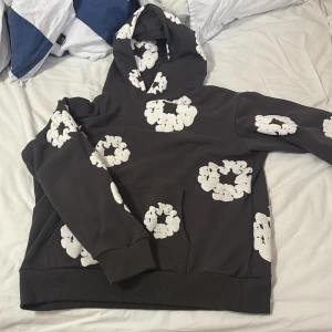 Mörkgrå  hoodie från Denim Tears med - Säljer denna mörkgråa denims tears hoodien, köpt när jag var i USA. Jag har tyvärr blivit lite väl stor så den passar inte mig längre. Storlek M, priset kan diskuteras. Mer information privat!!!
