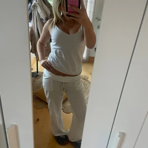 Vita linnebyxor med snörning - Säljer ett par vita linnebyxor med bred resår och snörning i midjan. sidfickor och är riktigt sköna och luftiga. Perfekta för chill dagar eller när du vill ha en avslappnad look.