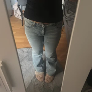Ljusblå bootcut jeans H&M Divided - Snygga ljusblå jeans från H&M Divided i bootcut-modell. Jeansen har låg midja och klassisk femficksdesign. Tillverkade i bomull med en skön passform och lätt utsvängda ben. Perfekta för dig som gillar en avslappnad och trendig look.