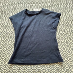 Svart och vit linnetopp från Gina Tricot - Två stilrena linnetoppar från Gina Tricot i svart och vit. Modellen är ärmlös med rund hals och rak passform, perfekt för en clean och enkel look. Materialet är mjuk bomull som känns skönt mot huden. Säljes tillsammans eller separat, skriv vid intresse! Nytt skick utan kvitto 