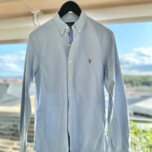 Ralph Lauren Oxfordskjorta - Ralph Lauren- Oxfordskjorta   Pris: 699kr Nypris (Ralphlauren.com): 1795kr❌  Klassisk Oxfordskjorta ifrån Ralph Lauren i baby blå/himmelsblå färg, perfekt till både vardag & helg.  Använd totalt ca 10-15 gånger sedan jag fick den (1.5 år sedan).  Info -Storlek: S, slim-fit  -Skick: 9/10 -Fraktas inom: 24 timmar -Frakt kostnad: 69-80 kr  Tveka inte på att slå en signal vid fler bilder, frågor eller köp.  MvH EP🔹