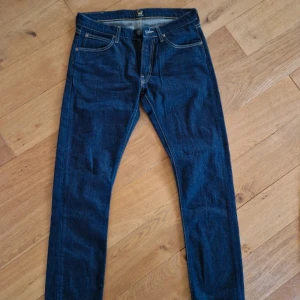 Mörkblå jeans från Lee w31 L30 - Nya Snygga mörkblå jeans från Lee med klassisk femficksdesign och kontrastsömmar. 