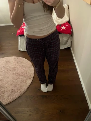 Rutiga pyjamas byxor  - Jag säljer dessa pyjamas byxor en en mörkrött och mörkblått Rut mönster. Dess storlek är L men jag som i vanliga fall har S eller XS kan ha dem om man knyter utan att det ser konstigt ut. Jag har använt dem kanske max 5 gånger. 