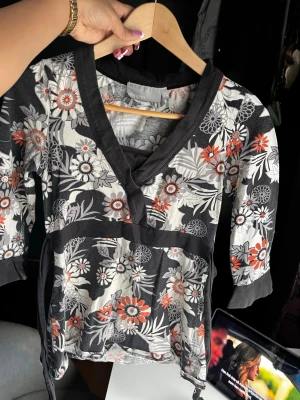 Blommig topp - En topp med blommor på som man kan knyta där bak. Från Kappahl storlek XS. 