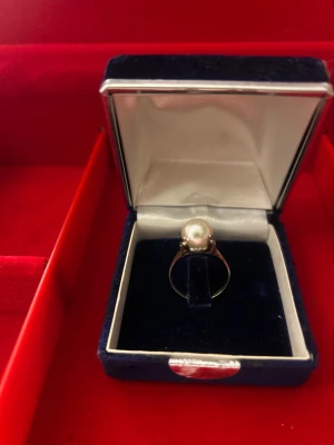 Ring äkta pärla. Guld testad på 8karat. Diameter 17,5mm. Vikt 2,8gram - Ringen har en klassisk och elegant design med smal ring och pärlan sitter stadigt i mitten. Perfekt för dig som gillar stilrena smycken med lite lyxig känsla.  Äkta pärla. Guld testad på 8karat. Diameter 17,5mm. Vikt 2,8gram. 