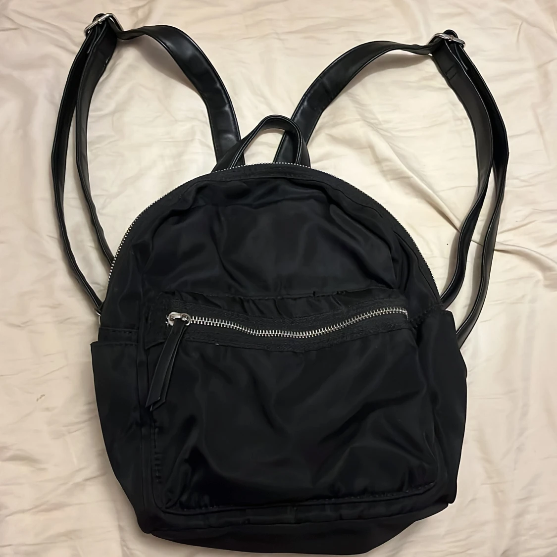 Svart ryggsäck med dragkedjor