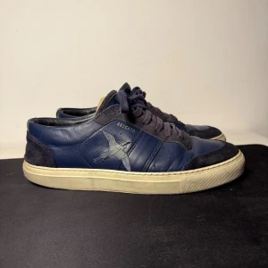Axel Arigato clean bird 90 - Sneakers i storlek 42 från Axel Arigato med den klassiska broderade fågeln på sidan. Tillverkade i mörkblått läder med detaljer i mocka. Nypris: 2300kr, köpta på Axel Arigatos hemsida.
