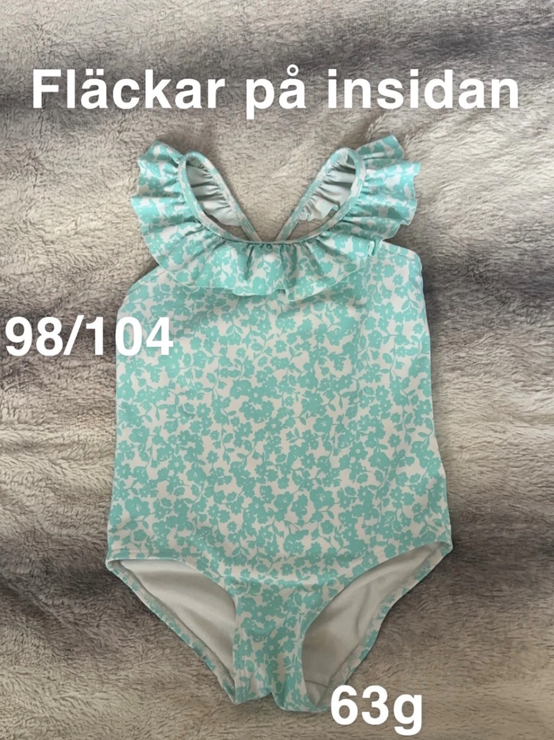 Blommigt turkost baddräkt med volang