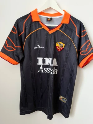 Roma/Totti-tröja - AS Roma-tröja från säsongen 1999-00 med legendaren Totti 10 på ryggen. Så gott som oanvänd. Storlek M.
