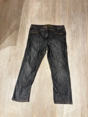 Mörkblå jeans från Prêt Jeans - Snygga mörkblå jeans från Prêt Jeans med klassisk femficksdesign och kontrastsömmar i orange. Jeansen har rak passform och normal midja, tillverkade i slitstarkt denimtyg. Perfekt för dig som gillar en enkel och tidlös stil. Öppen för bud!