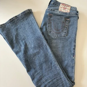 True Religion bootcut jeans blå - Säljer ett par blåa true religion jeans i mycket bra skick.  De har inga defekter eller slitningar och ser relativt nya ut. Midjemåttet är 38cm och de är ganska långa på mig och jag är 168 cm💕