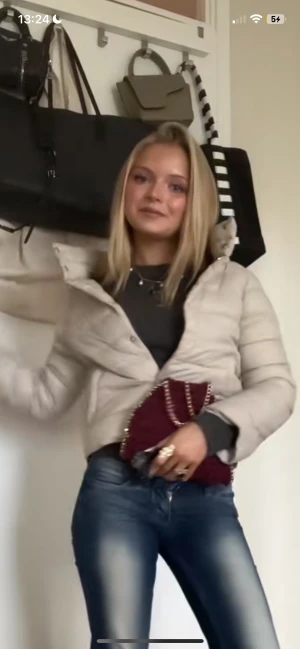 Trekvartsärmad jacka herno - Säljer en beige croppad pufferjacka med snygg quiltad design och hög krage. Jackan har långa ärmar och stängs med knappar framtill. Perfekt för dig som gillar en trendig och chill look under höst och vinter.