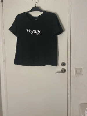 Svart t-shirt Voyage från Etirel - Pris kan diskuteras och tvätt ingår innan leverans 💗Svart t-shirt från Etirel i storlek M med trycket 'Voyage' i vitt på bröstet. Klassisk rund halsringning och korta ärmar. Skön och enkel modell i mjukt material, perfekt till jeans eller shorts.