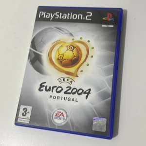 UEFA Euro 2004 Portugal (PlayStation 2) - UEFA Euro 2004 Portugal till PlayStation 2. Komplett med originalfodral och manual. Skivan har synliga repor men ser ut att vara i spelbart skick. Perfekt för samlare eller fotbollsfans som vill återuppleva turneringen på PS2.