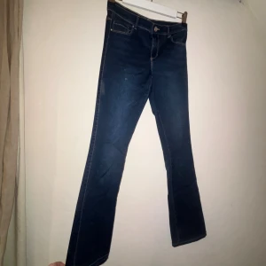 Mörkblå bootcut jeans - Snygga mörkblå jeans med bootcut passform och klassiska fem fickor. Jeansen har kontrastsömmar och normal midja. Perfekta för dig som gillar en tidlös look med lite utsvängda ben. Materialet är klassisk denim som sitter skönt hela dagen.säljer då jag tycker dom är förkorta för mig. Jag har sprättat upp i slutet av ben för att få dom längre. Dom är från barn avdelningen i strl 164