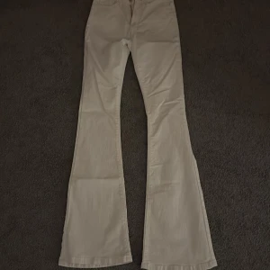 Vita bootcut byxor med fickor - Snygga vita byxor med bootcut-modell och klassiska bakfickor. Storlek XS. Säljer pga att dom inte kom till användning. 