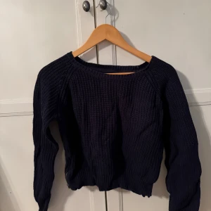 Mörkblå stickad tröja - Mörkblå stickad tröja med dragkedjor på sidorna. Från lager 157 storlek S. Tröjan slutar ungefär vid höfterna på mig, är 170 cm. 